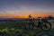 Black electric bicycle with sunset on light green meadow in spring evening