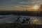 Black electric bicycle with sunset near weir on Malse river