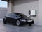 Black electric car charging at home charging station