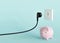 Black electrical plug, electric socket and piggy bank. Ready to connect. Free, copy space for your text, advertising