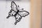 black embroidered butterfly representation on translucent curtain fabric