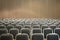Black empty seats in the audience prepared for the participants of the conference or presentation. Organization and holding of