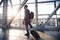 Black Entrepreneur Man Walking With Travel Suitcase In Airport Indoors