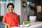 Black entrepreneur smiling at the camera while sitting at home