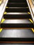 The black escalator with yellow edges, move into the higher floor. Concept, people who are moving forward towards a better life.