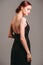 Black evening dress. Elegant lady in full-length backless sleeveless vintage gown with straps