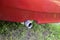 Black exhaust pipe of a car with a red bumper