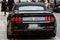 A black, expensive sports muscle car parked on the edge of a city street, London, England, UK