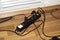 Black extension cord with button and wires