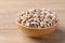 Black eye peas or cowpeas in bowl on wooden background