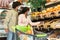 Black Family Couple Choosing Groceries Shopping Wearing Masks In Supermarket