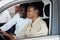 Black family examining car from inside