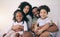 Black family, happiness and portrait of a mother, father and girl children on a bed with a smile. Bedroom, home and