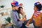 Black family in living room on fourth of July with flags smiling