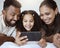 Black family, phone and child on bed for video, smile or happy for streaming, cartoon or movie. Mom, dad and kid with