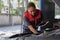 A black female automotive mechanical worker checks EV car at a fixing garage.