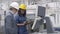 Black female industrial professional standing at control panel