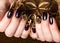 Black female manicure nails closeup with crown