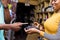 black female merchant in a retail store using a mobile point of sale system to process a customer& x27;s payment