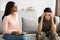 Black female psychologist talking to depressed female soldier suffering ptsd