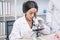 Black female scientist use microscope and test tube chemical ingredient to conduct research in laboratory,test sample antibiotics