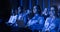 Black Female Sitting in Dark Crowded Auditorium at an International Business Conference. Multiethnic