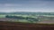 Black fertile soil on a sprinkled spring field. Landscape