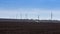 Black fertile soil on a sprinkled spring field. Landscape