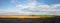 Black fertile soil on a sprinkled spring field. Landscape