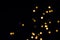 Black festive background. Gold hexagonal bokeh lights fall and shine