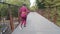 Black fitness woman in activewear running on bridge outdoor during everyday morning workout. Young athletic beautiful