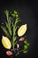 Black food background with fresh aromatic herbs and spices, copy
