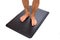 Black foot mat with barefoot standing.