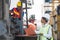 Black foreman worker driving forklift checking at Container cargo harbor to loading containers. African dock female staff using