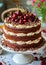 Black Forest Cake Adorned with Fresh Cherries on a Classic Cake Stand. Cherry and chocolate cake