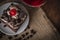 Black Forest Cake topping cherry putting on the white plate on the sack and wood background there are coffee bean and glass placed