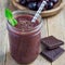 Black forest smoothie with cherry, almond milk and cacao powder in glass jar, square format