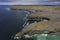 The Black fort by the ocean and cliffs and rugged stone terrain of Aran Island. Warm sunny day and blue cloudy sky. Popular travel