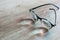 Black frame eyeglasses with myopia lenses on a wooden table.