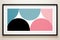 a black framed art print with pink blue and black circles