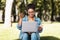 Black Freelancer Woman Using Laptop Making Video Call Sitting Outside