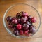 black fresh freshly picked cherries in bowl on wooden table..