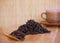 Black friable tea in a wooden spoon and on a wooden tray