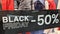 Black friday banner -50% sign on windows store of commercial shop