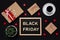 Black Friday sale. Presents, coffee, red stars and blackboard with words in wooden letters on dark background. Shopping