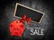 Black Friday sale text blackboard and piggy bank with red ribbon