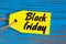 Black Friday sales tag. Yellow color tags on blue wooden background