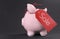 Black Friday shopping sale concept with red ticket Sale tag hanging from piggy bank