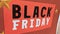 Black friday text sign on red stickers on store windows entrance for discount price