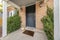 Black front door entrance of a house with lockbox and holloween decorations